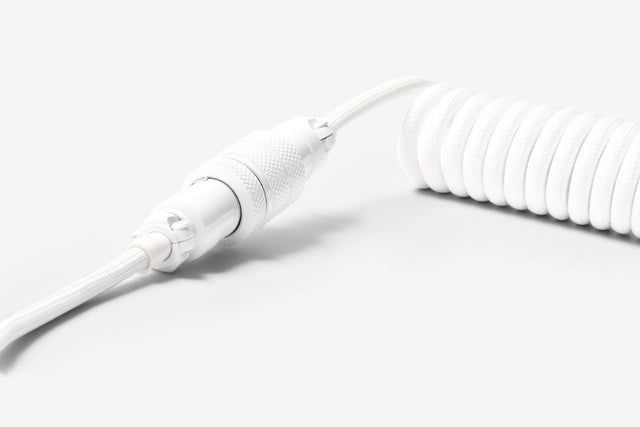 connection close up of white akb coiled cable