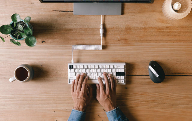 man typing on tofu 60 white mechanical keyboard